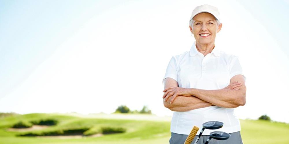 Senior woman smiling at golf resort