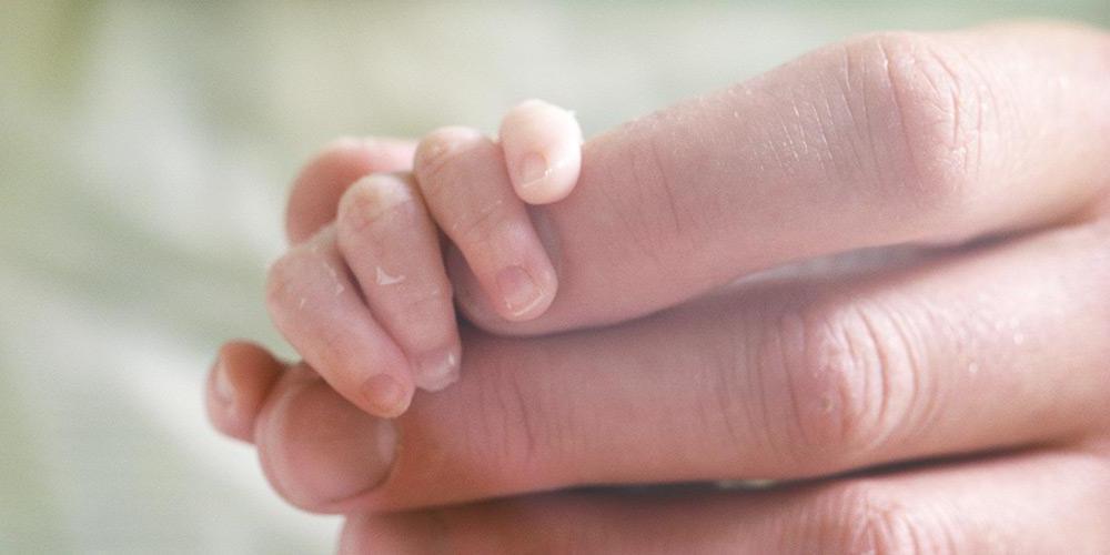 Baby hand inside mothers hand